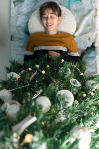 Boy under Christmas tree